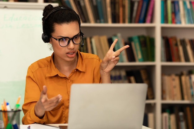 remote distant communication concept mixed race female teacher headphones talking gesturing laptop webcam 116547 30899 1