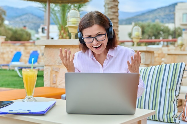 woman with headphones looking laptop talking using video call 116407 21187